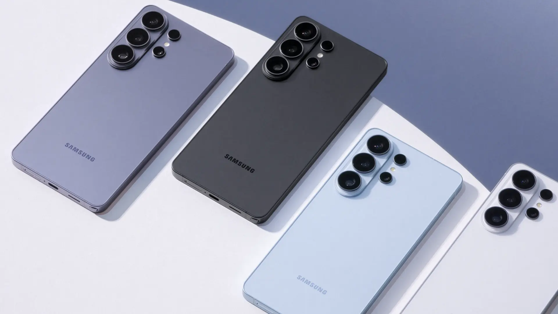 Four Samsung smartphones shown from the back, arranged diagonally on a light surface, highlighting their large multi‑camera rear modules in purple, gray, blue, and white/silver colors.