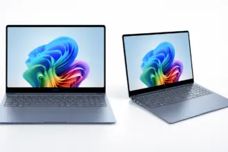 Two slim laptops open on a white surface, displaying a vibrant abstract wallpaper on their screens.