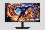 Samsung Odyssey G8 gaming monitor displaying a sci-fi character surrounded by fiery rings; bold, cinematic wallpaper on screen